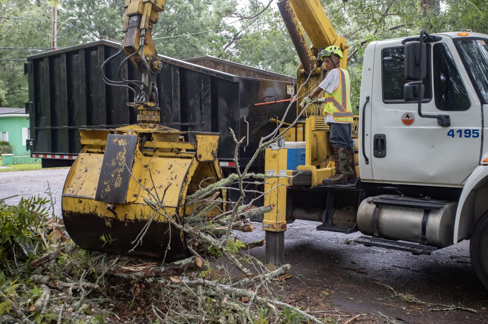 A vehicle lifting storm damaged leaves