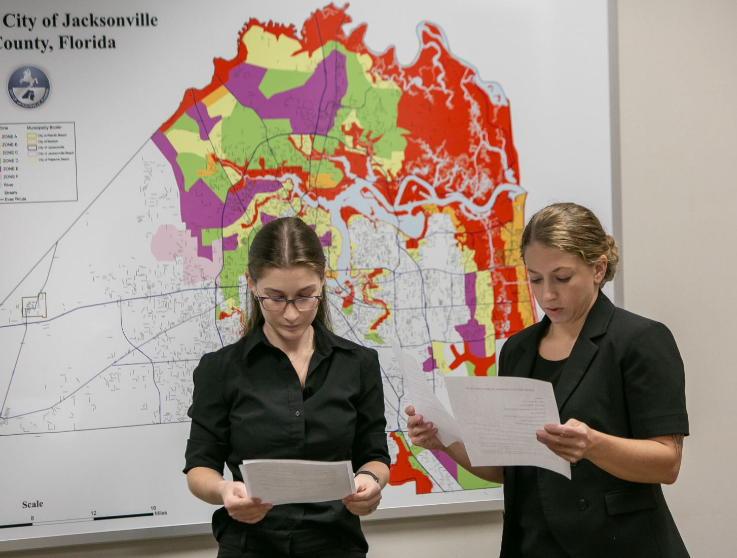 Two people reading about evacuation zones