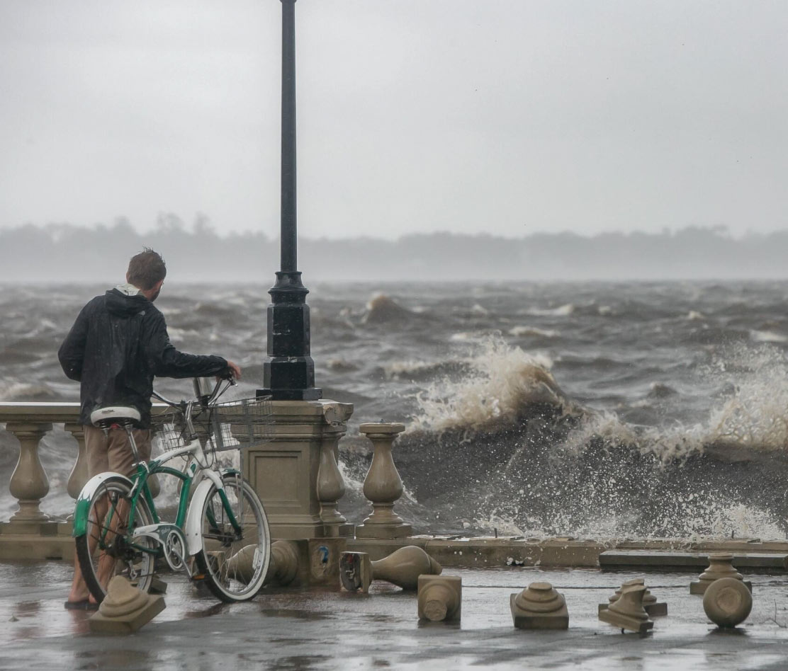 A man standing at a destroyed pier